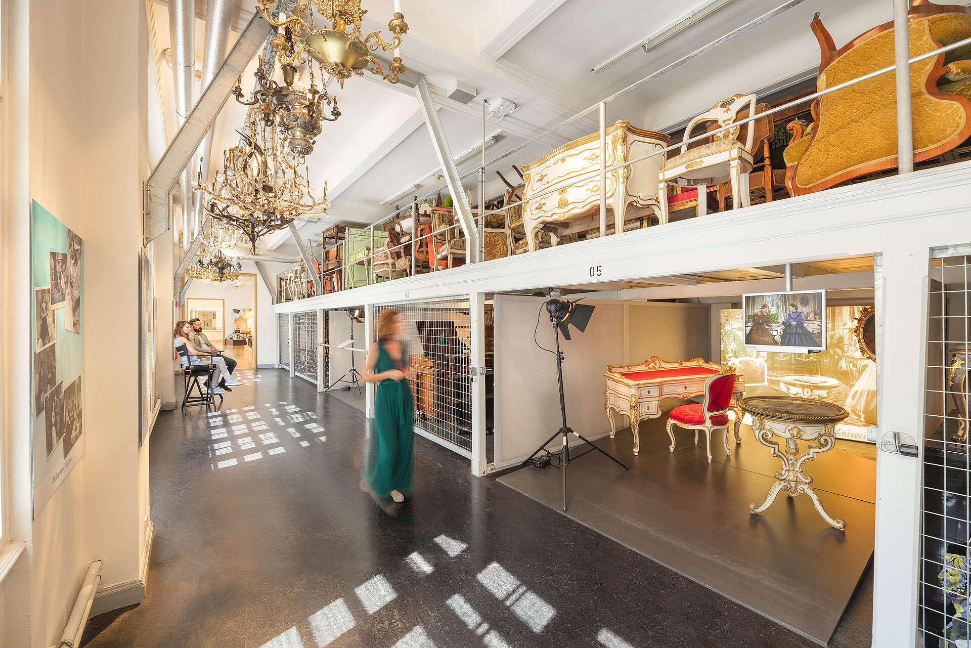 Woman walks through the walk-in depot at the Vienna Furniture Museum